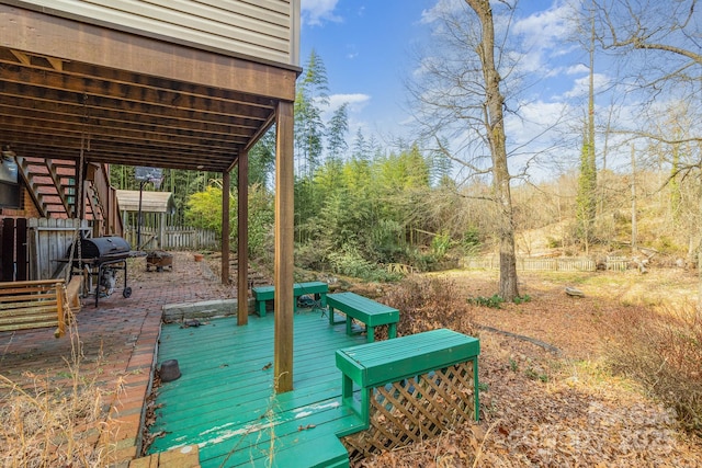 wooden terrace featuring fence, stairway, and area for grilling