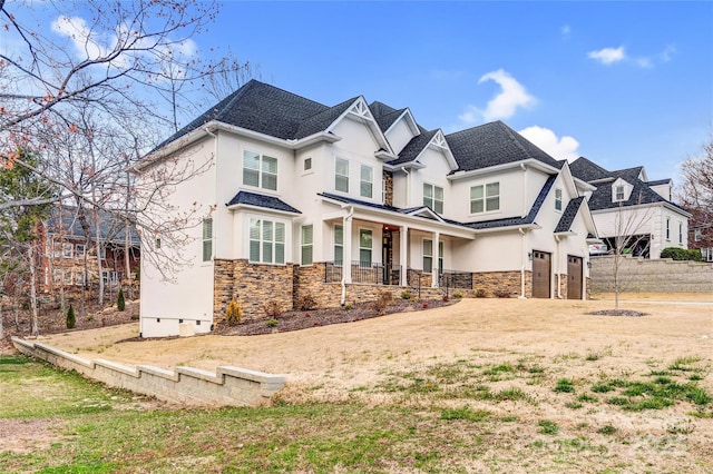 view of front of home with covered porch, stone siding, a garage, and stucco siding