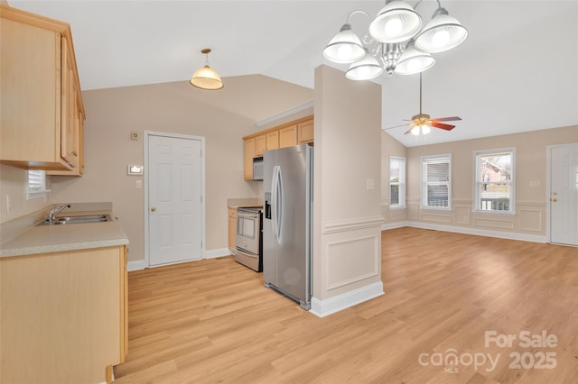 kitchen with light wood-style flooring, a sink, light countertops, appliances with stainless steel finishes, and light brown cabinetry