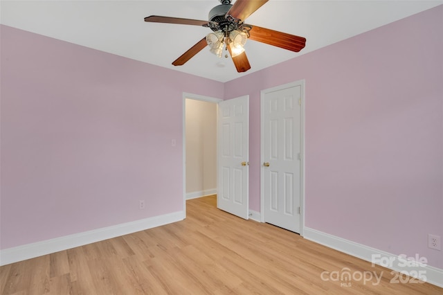 unfurnished room with ceiling fan, light wood-style flooring, and baseboards