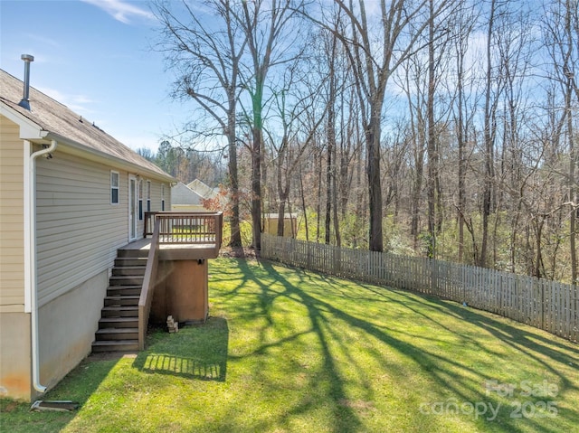 view of yard featuring stairs, a deck, and fence