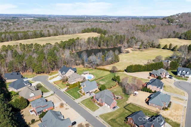 drone / aerial view with a residential view and a view of trees