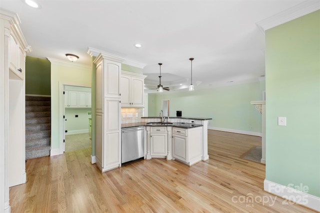 kitchen featuring a peninsula, dark countertops, ornamental molding, and dishwasher