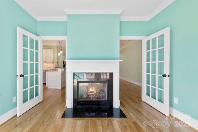 interior details with ornamental molding, decorative backsplash, wood finished floors, and a multi sided fireplace