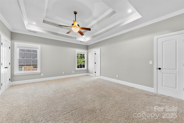 carpeted empty room featuring baseboards, ceiling fan, a tray ceiling, crown molding, and recessed lighting