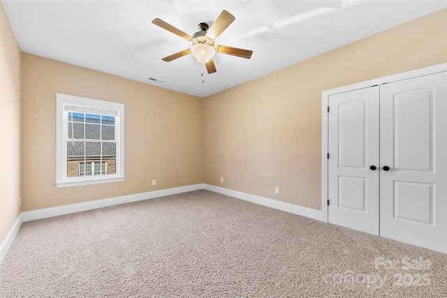 unfurnished bedroom with carpet, a closet, visible vents, and baseboards