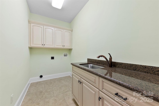 clothes washing area with cabinet space, light tile patterned floors, baseboards, washer hookup, and a sink