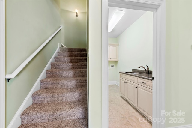 stairway featuring baseboards and tile patterned floors