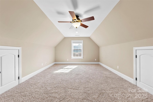 additional living space featuring light carpet, baseboards, vaulted ceiling, and a ceiling fan