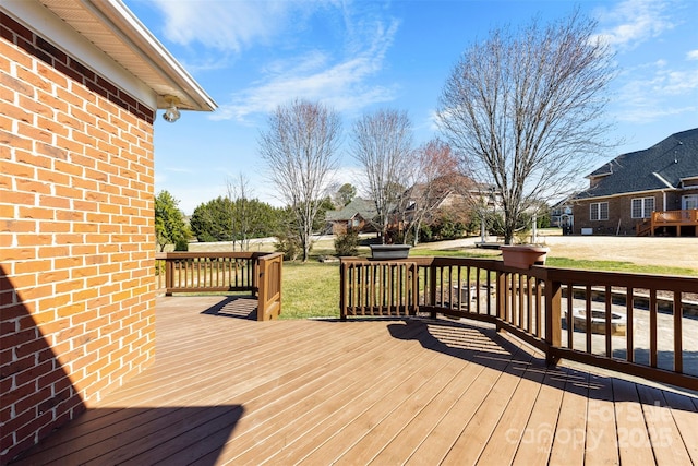 wooden deck featuring a yard