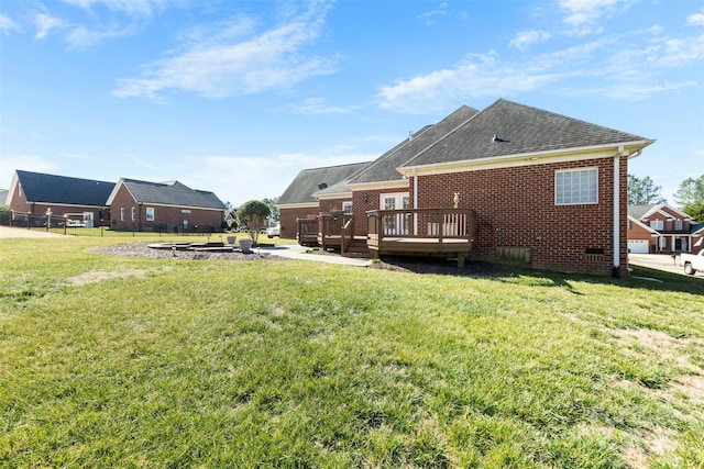 view of yard featuring fence and a wooden deck