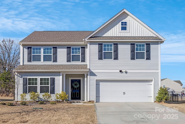 view of front of house with an attached garage, a shingled roof, fence, driveway, and board and batten siding