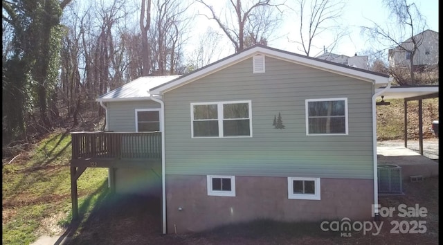 view of side of property featuring central AC unit