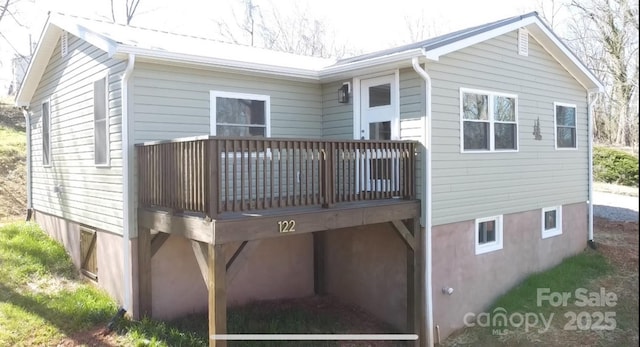 rear view of house featuring a deck