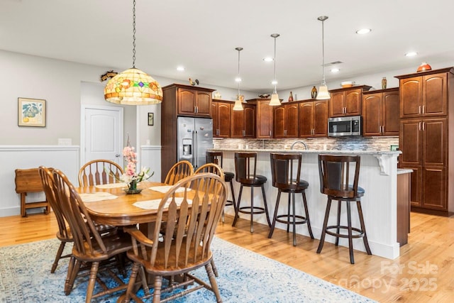 dining area featuring light wood-style floors and recessed lighting