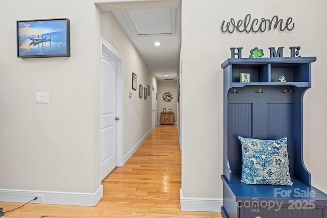 hallway with recessed lighting, light wood-type flooring, and baseboards