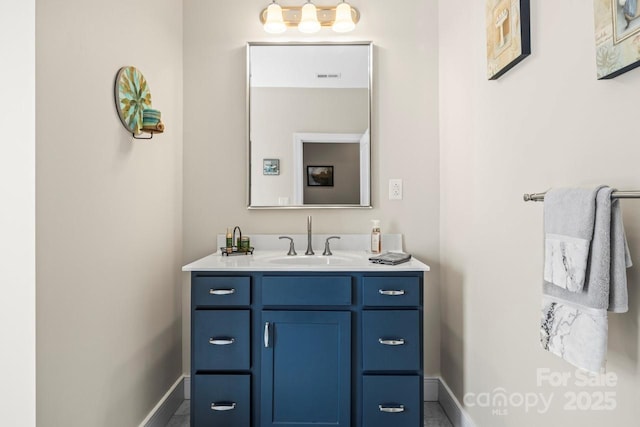 bathroom with baseboards, visible vents, and vanity