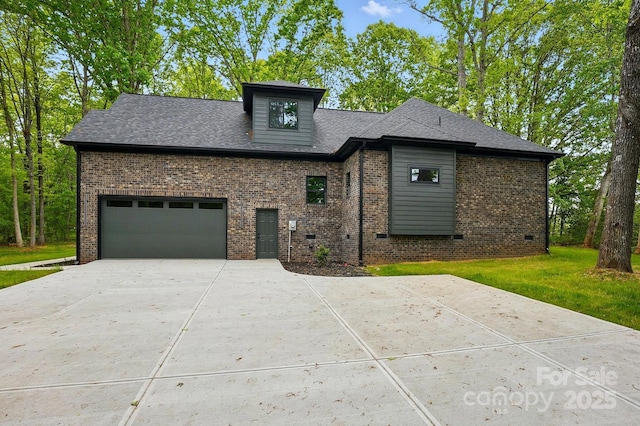 view of front of home featuring an attached garage, concrete driveway, a front lawn, and brick siding
