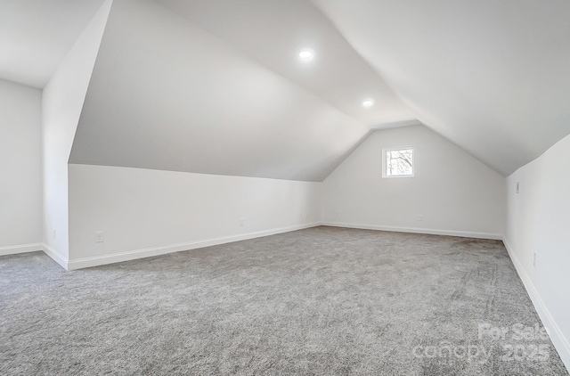 additional living space with recessed lighting, baseboards, vaulted ceiling, and carpet