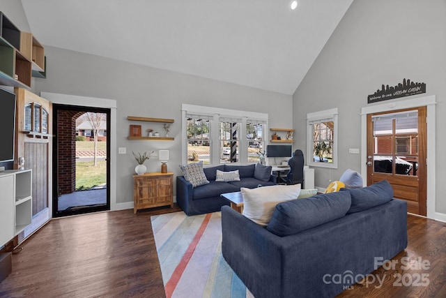 living room featuring high vaulted ceiling, wood finished floors, and baseboards