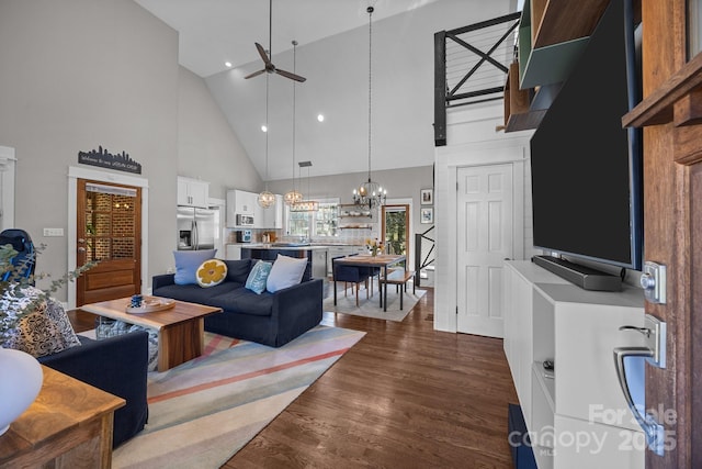 living room with high vaulted ceiling, a chandelier, dark wood finished floors, and recessed lighting