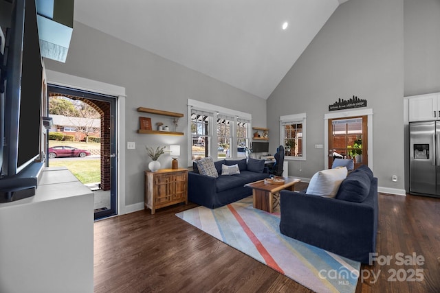 living room featuring high vaulted ceiling, dark wood finished floors, and baseboards