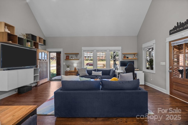 living room with baseboards, high vaulted ceiling, wood finished floors, and a healthy amount of sunlight