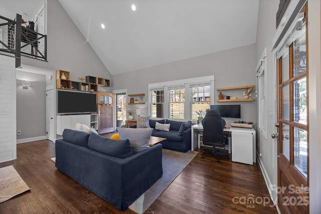 living room with baseboards, high vaulted ceiling, and dark wood-type flooring