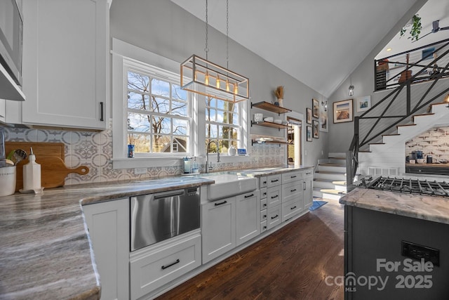 kitchen featuring lofted ceiling, dark wood-type flooring, a sink, and white cabinetry