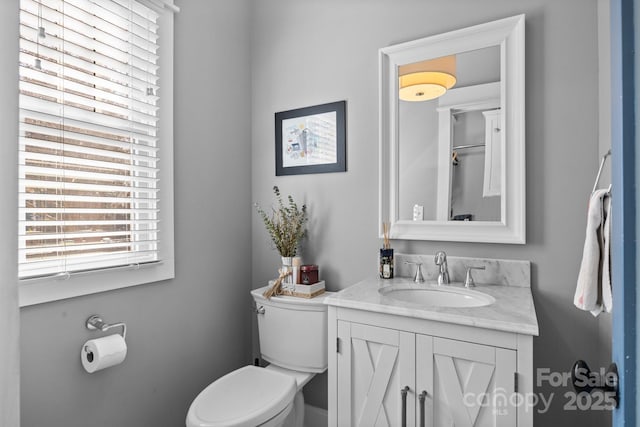 bathroom with toilet and vanity