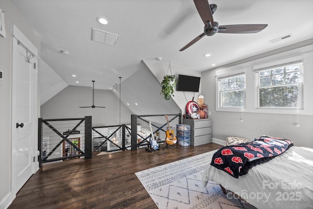 bedroom featuring lofted ceiling, wood finished floors, visible vents, and recessed lighting