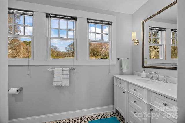 bathroom with vanity and baseboards