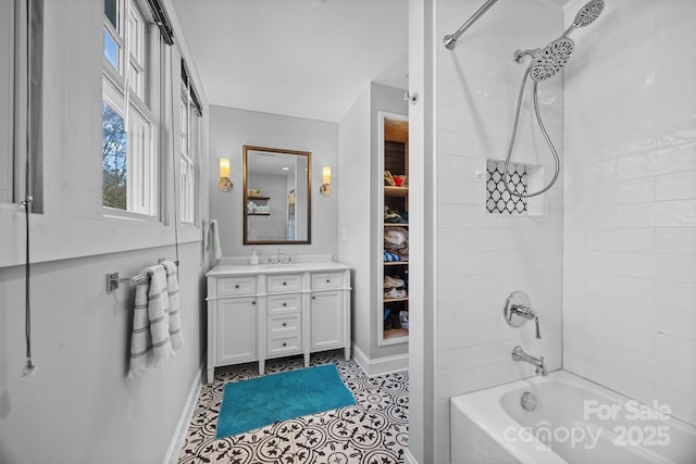 bathroom with vanity, baseboards, and bathing tub / shower combination