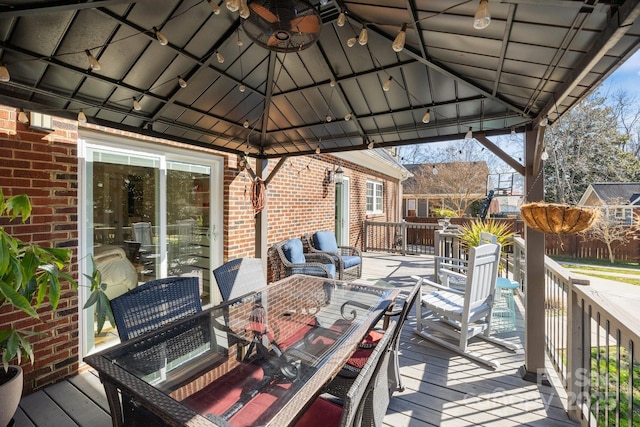 deck with a gazebo and outdoor dining space