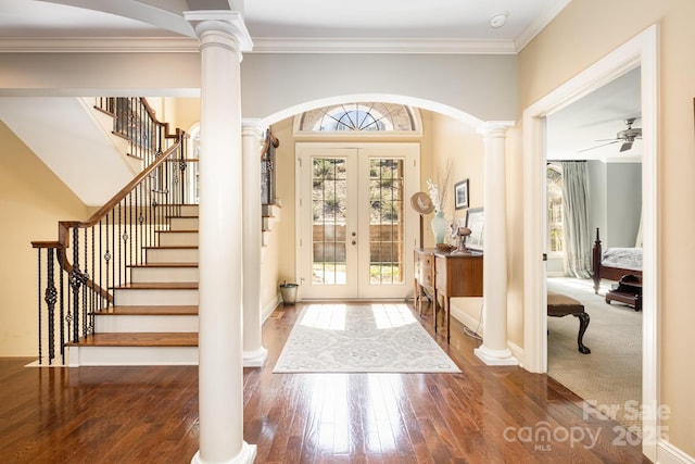 entryway featuring arched walkways, french doors, and decorative columns