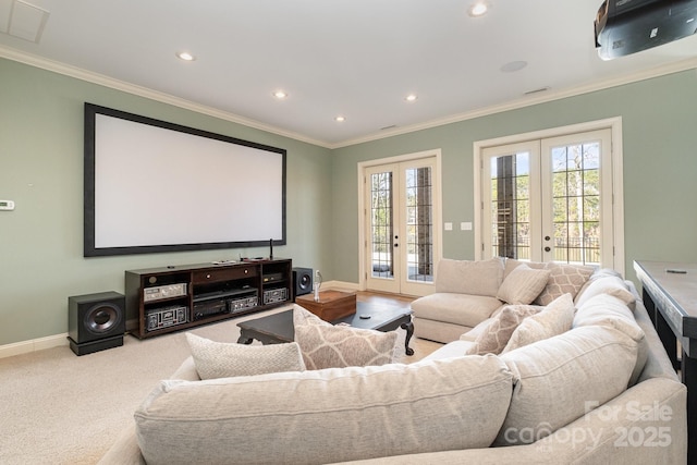 carpeted home theater room with crown molding, french doors, and a healthy amount of sunlight