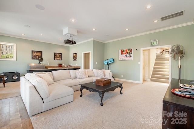 carpeted living area featuring visible vents, stairs, baseboards, and ornamental molding