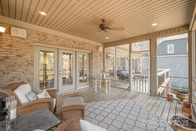 sunroom with wood ceiling, a ceiling fan, and french doors