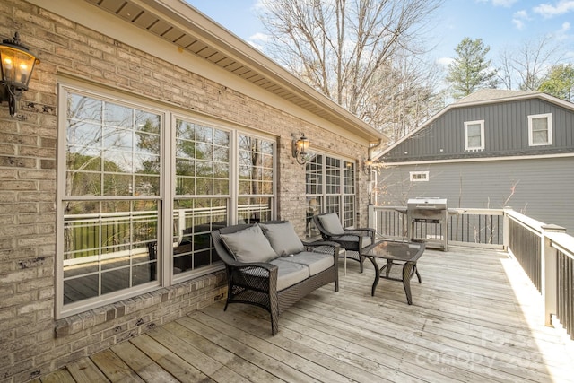 wooden deck with an outdoor living space and a grill