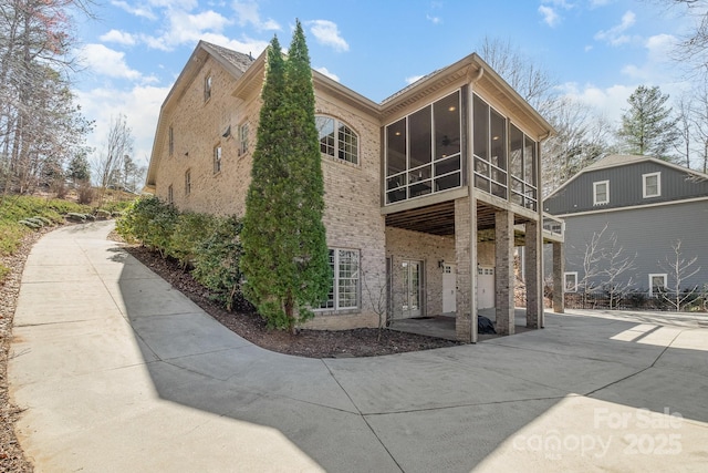 exterior space featuring a patio and a sunroom