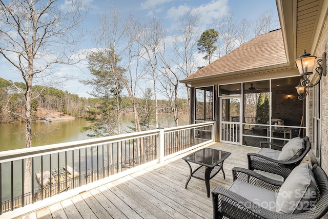 wooden terrace featuring a water view and a sunroom