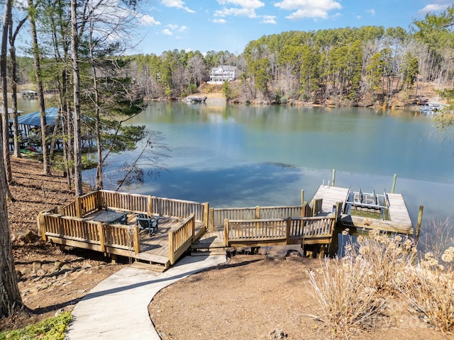 dock area featuring a view of trees and a water view