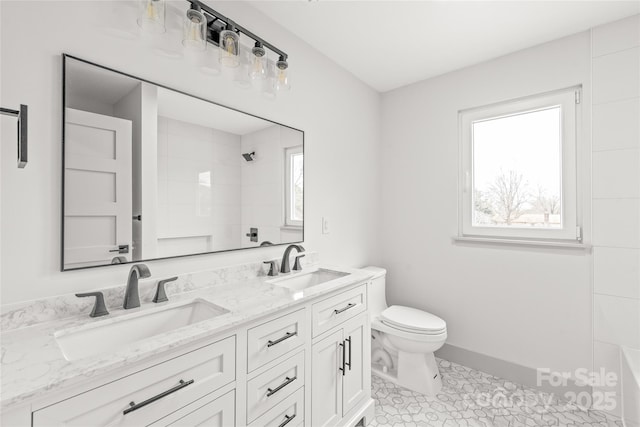 bathroom with a shower, a sink, toilet, and double vanity