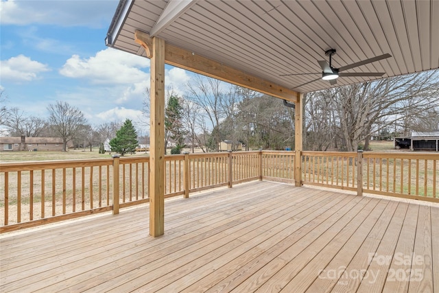 wooden deck featuring ceiling fan