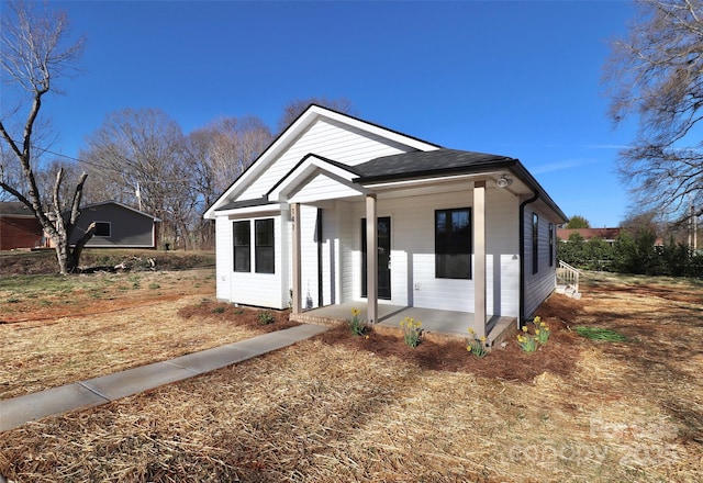 view of front of house featuring roof with shingles