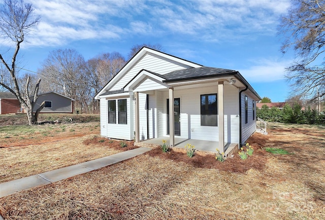 bungalow-style home featuring a shingled roof