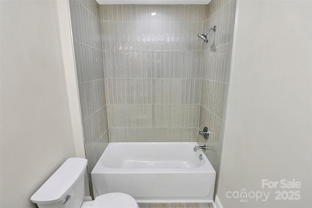 bathroom featuring toilet and shower / washtub combination