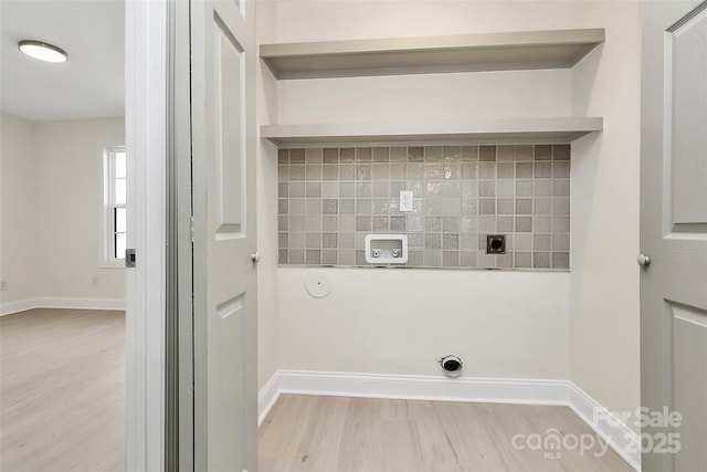 washroom with gas dryer hookup, light wood-style floors, baseboards, and electric dryer hookup