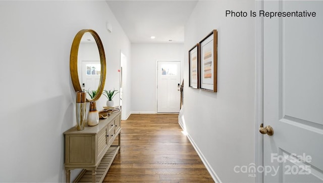 hallway featuring recessed lighting, wood-type flooring, and baseboards