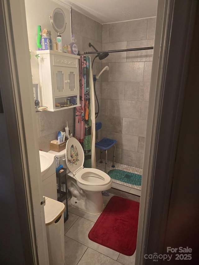 bathroom with vanity, a stall shower, tile patterned flooring, and toilet